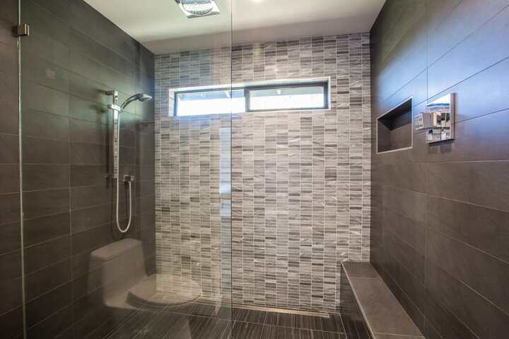 Am open country design for shower installation with colored tile in Simi Valley, California